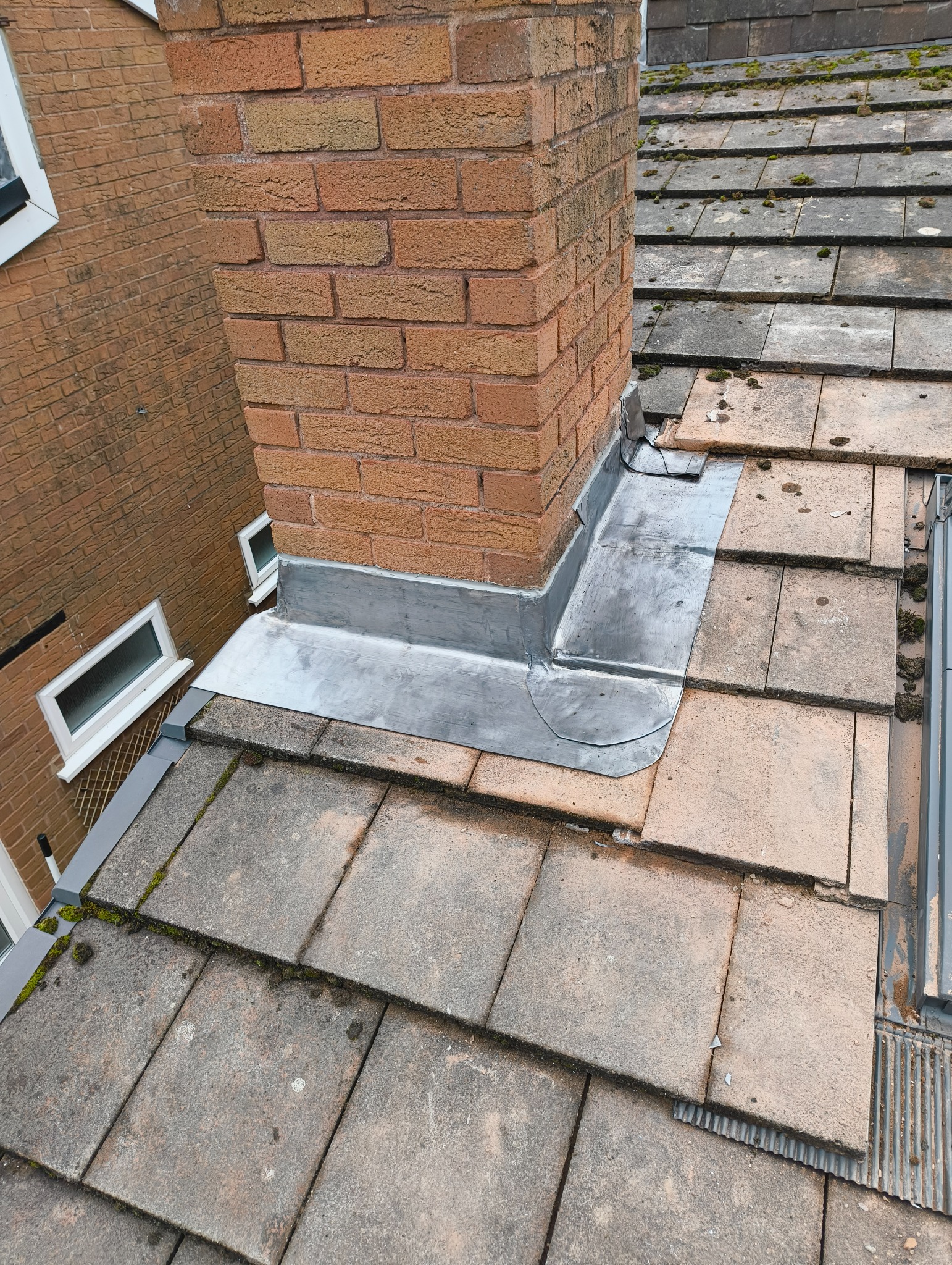 A T Roofing lead flashing around a chimney